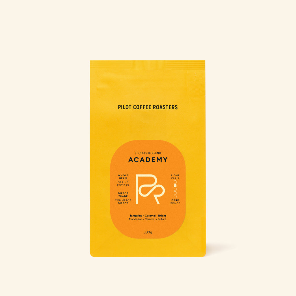 Pilot Coffee Roasters Academy coffee bag in bright yellow with an orange label.