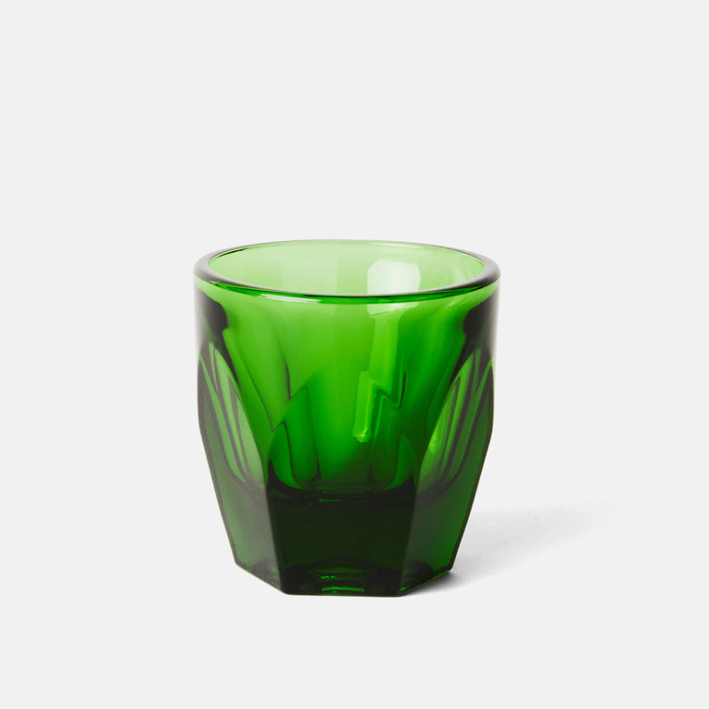 Emerald green cortado faceted glass heavyweight tumbler with a chunky geometric silhouette and smooth rim.