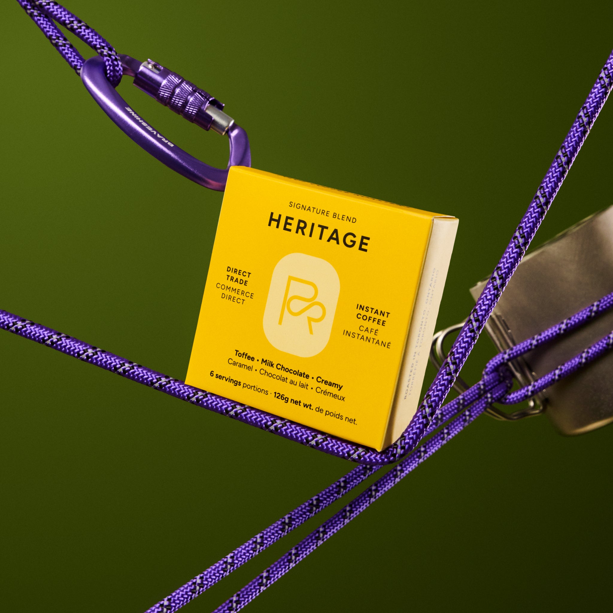 Bright yellow Heritage Instant Coffee box surrounded by purple cords