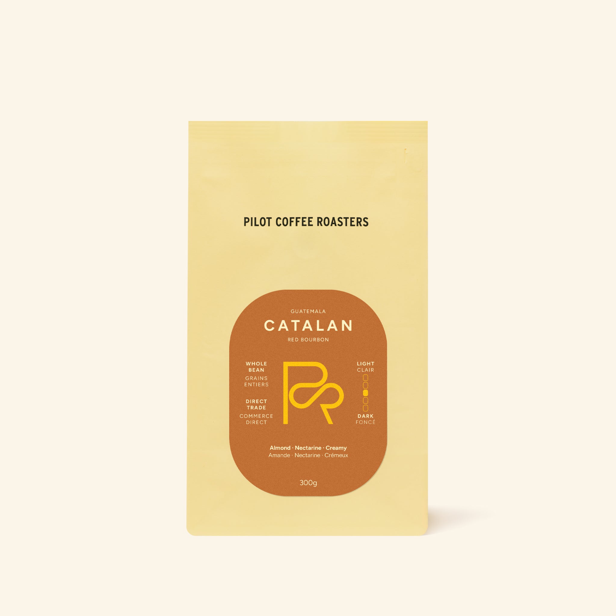 Close-up of Catalan Red Bourbon Guatemala coffee bag with a round label on pale yellow packaging.