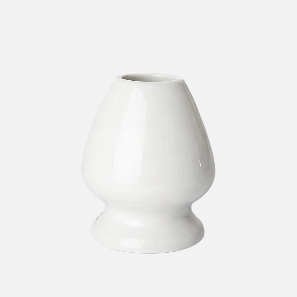 White ceramic stand for storing a matcha whisk to help maintain its shape