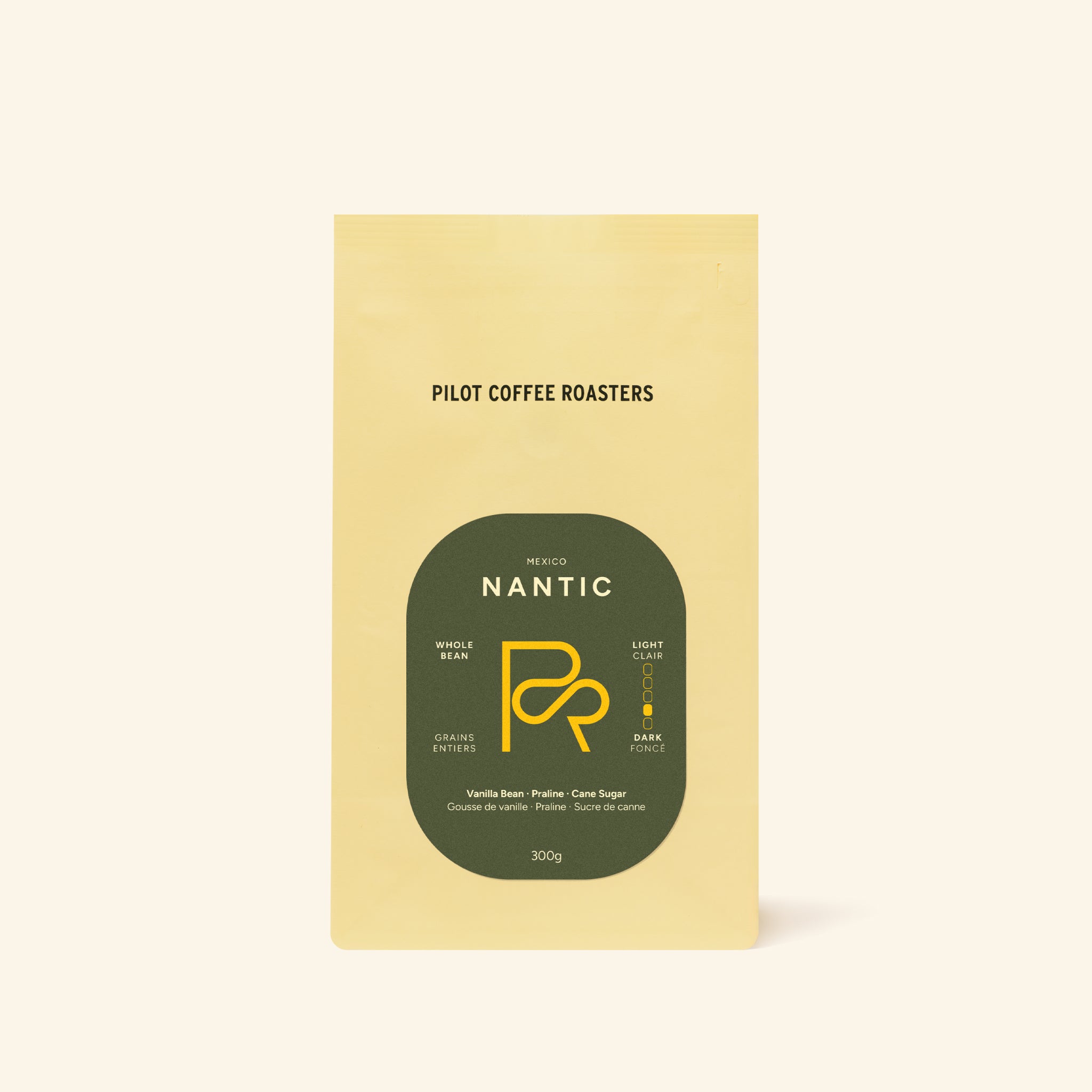 Nantic Mexico coffee bag with a green circular label on a pale yellow pouch