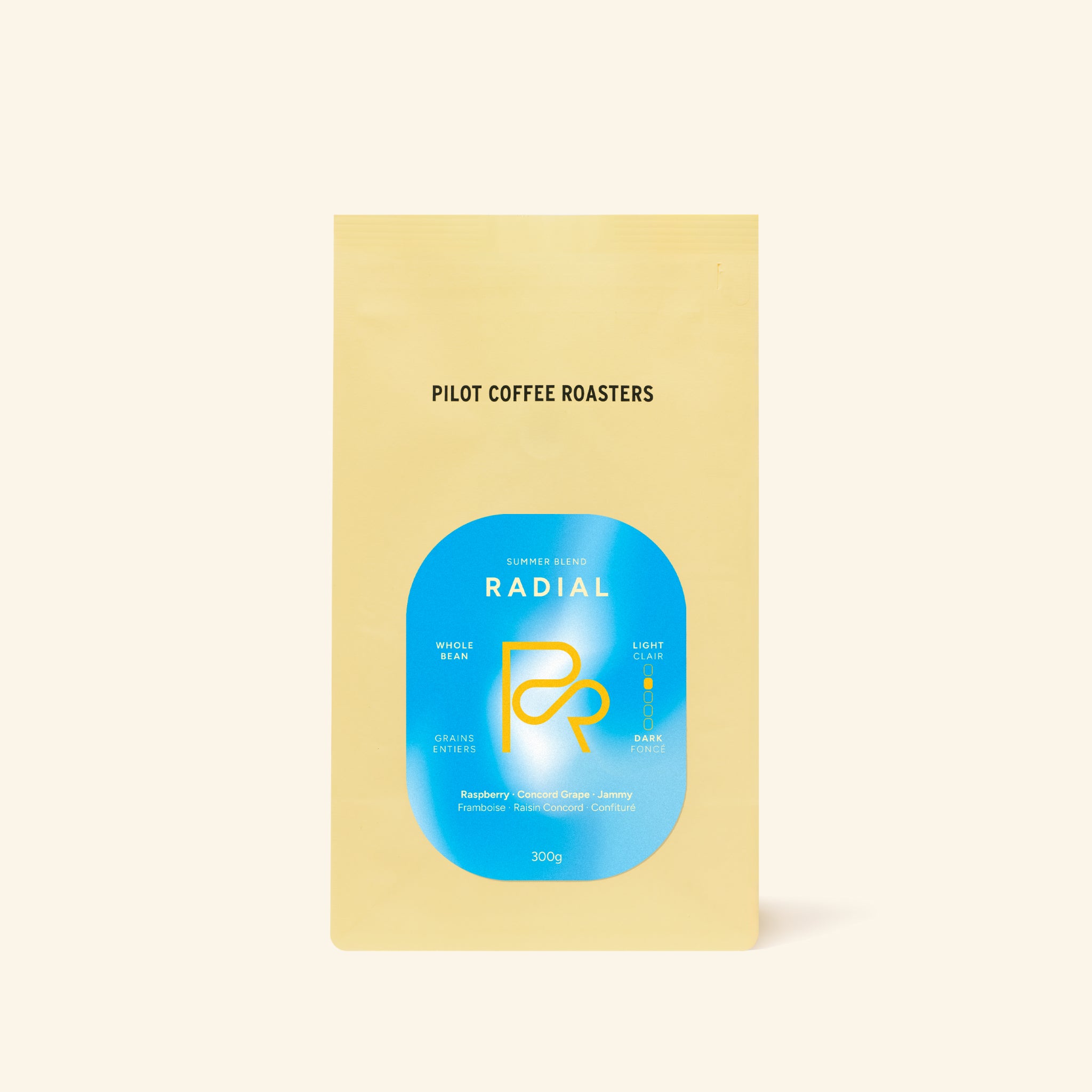 Radial Summer Blend coffee bag with a bold blue circle logo on pale yellow packaging.