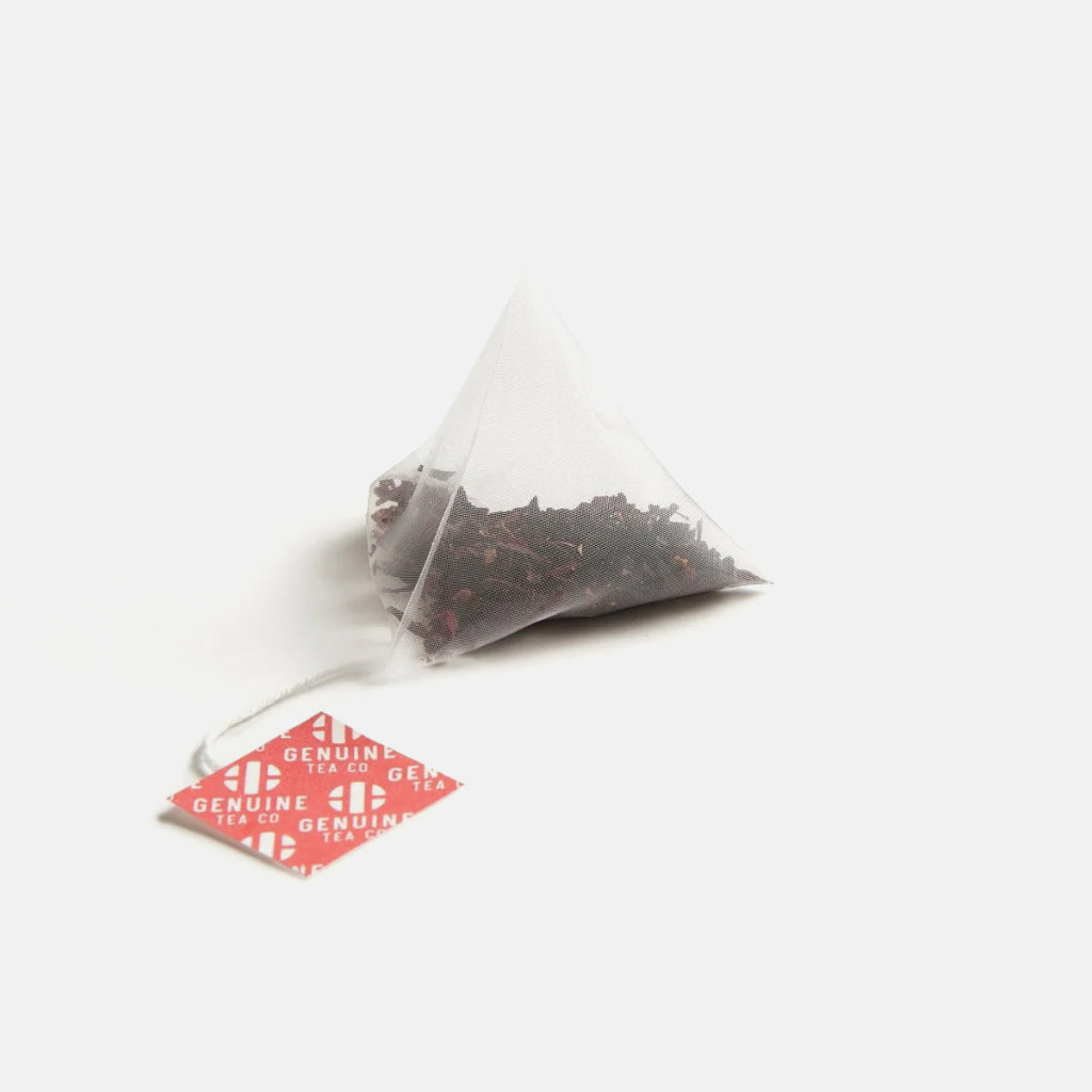 Pyramid tea bag with string and red Genuine Tea Co tag for Organic Elderberry Hibiscus
